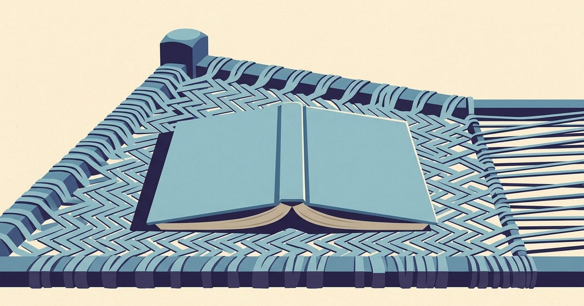 An open cloth-bound book resting face down on a woven charpai