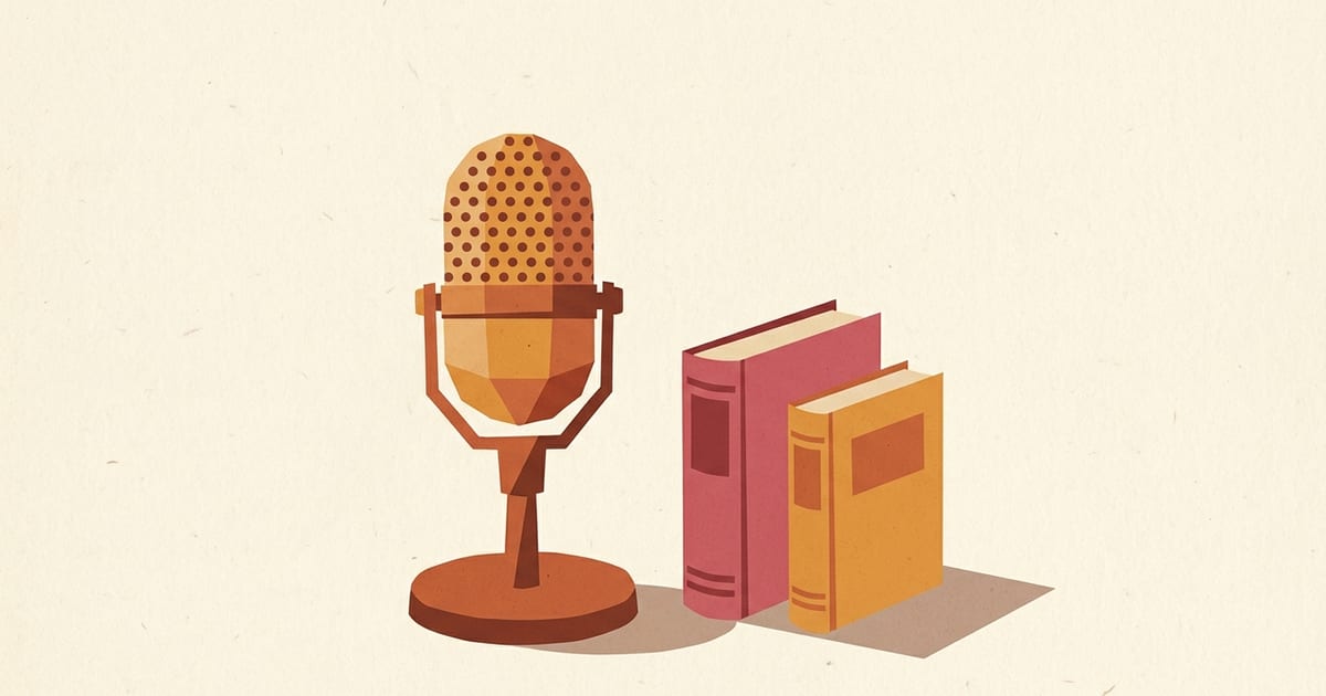 A vintage table microphone beside two closed hardcover books