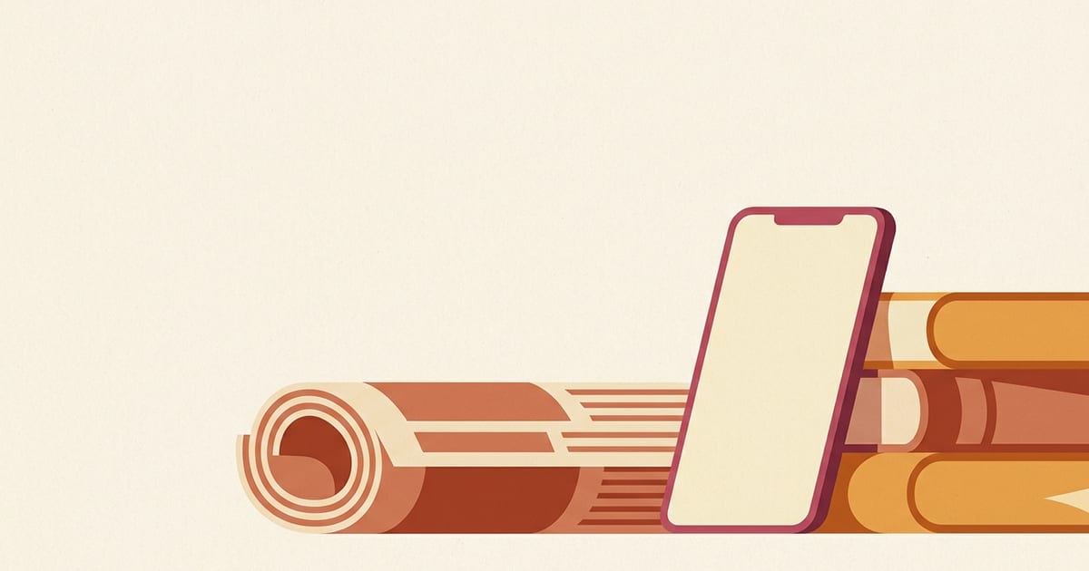 A rolled newspaper and a smartphone leaning against a stack of books